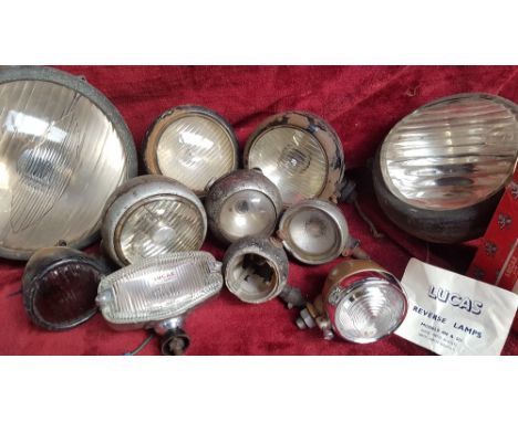 A NOS Lucas reverse lamp, model 494/511, together with other lamps.