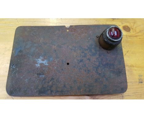 A vintage/veteran rear number plate with electric lamp.