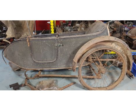 A vintage sidecar on chassis, unknown make, with hinged door and boot.