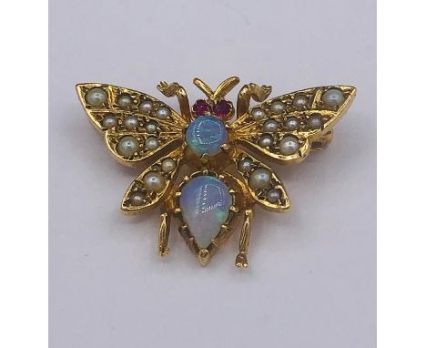 An Opal Butterfly brooch in yellow metal, comprising foir wings, each grain set with a series of split pearls, 24 in total, t