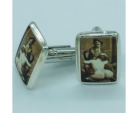 A pair of silver and enamel cufflinks with erotic image