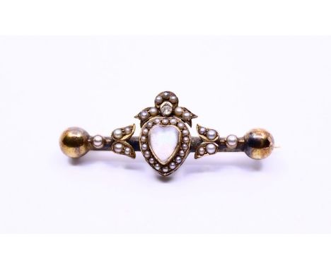 A late Victorian moonstone, pearl and diamond brooch with heart-shape moonstone to the centre within border of seed pearl and