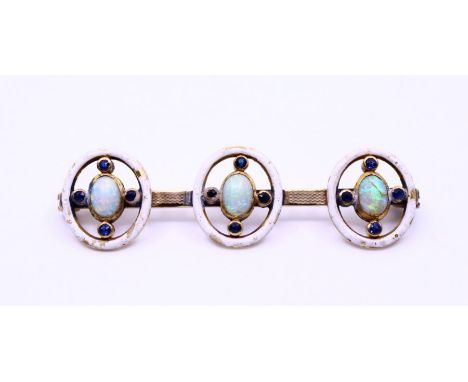 A 9ct yellow gold opal and sapphire brooch with three opals on barmounnt each set oval cabochon opals surrounded by four smal