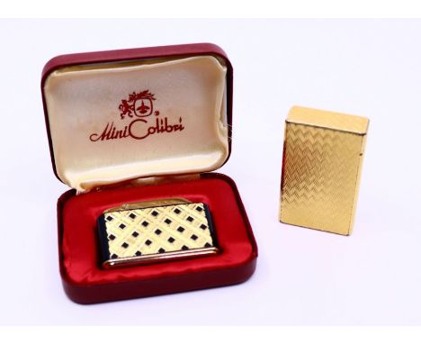 Two lighters to include a yellow metal Hermes lighter (2)
