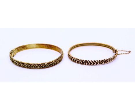 A 9ct bangle, weight: approx.10.49g together with an yellow metal bangle.&nbsp;