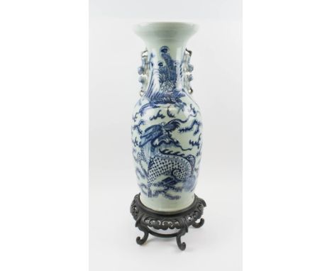 CHINESE BLUE/WHITE CERAMIC VASE, of baluster form with flared neck, decorated a chasing dragon, 59cm H, plus a stand.