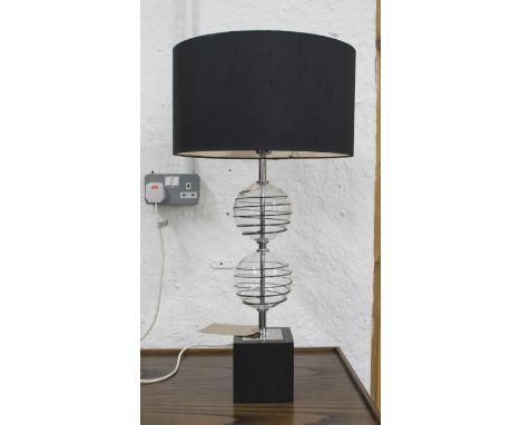 TABLE LAMP, two glass spheres with a black shade, 68cm H overall.