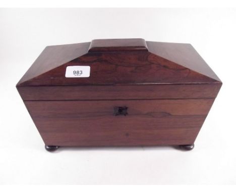 An early 19th century rosewood sarcophagus form tea caddy with two fitted caddies within