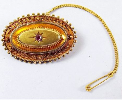 A Victorian 9ct gold oval brooch set ruby