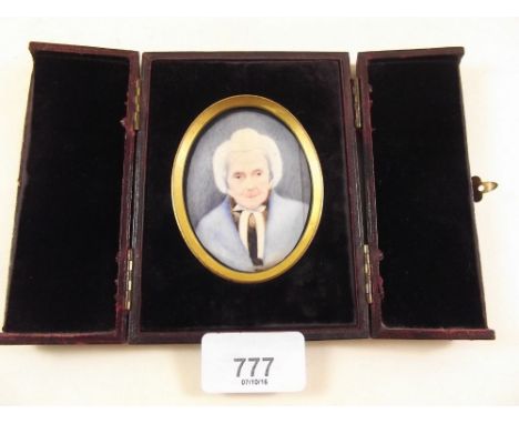 A Victorian watercolour on ivory miniature portrait of an old woman in folding leather frame 