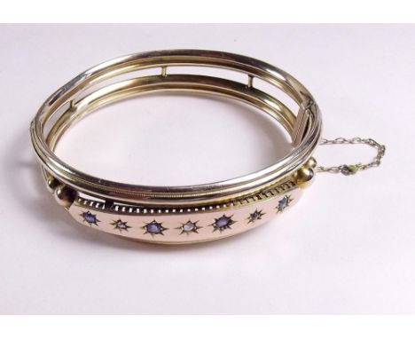 A 9ct gold Edwardian hinged bangle set sapphires and diamonds - 13g