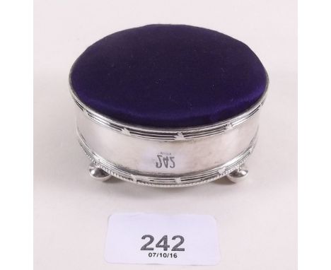 A silver circular pin cushion on bun feet - London 1906