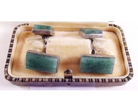A pair of jade cufflinks set in white metal