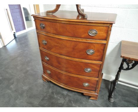 A late 20th century mahogany bow front chest of four long graduated drawers, in the Georgian style on bracket feet