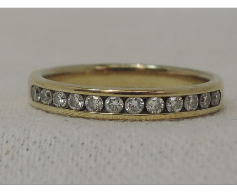 A lady's 9ct eternity ring having twelve channel set diamonds, approx 0.20ct, size I/J 
