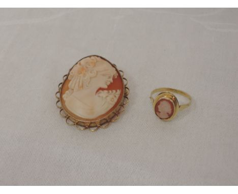 A conche shell cameo brooch depicting a maiden in profile in a 9ct gold decorative mount and a matched conche shell cameo dre