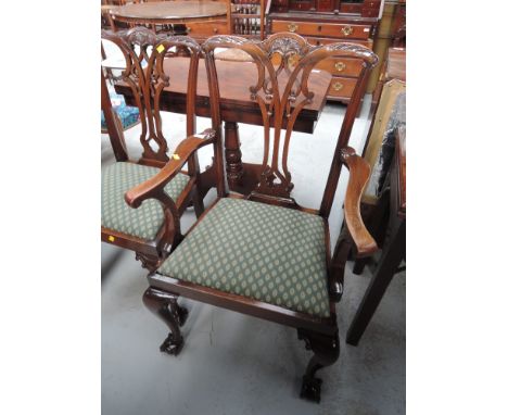 A set of six (5+1) modern mahogany dining chairs in the Chippendale revival style having vase backs, with green drop in seats