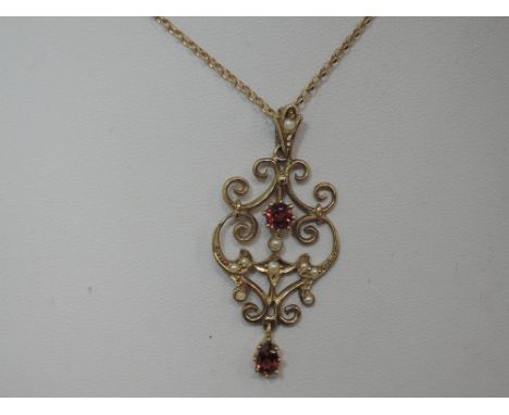 A modern 9ct gold pendant in the Edwardian style having seed pearl and ruby decoration on a 9ct gold belcher chain, approx  2