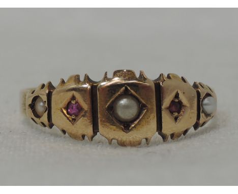 A lady's Victorian dress ring having seed pearl and ruby chip decoration on a 15ct gold loop, size N2.0g