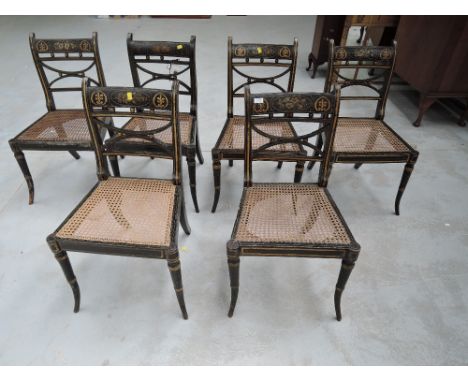 A set of six early 19th century Regency chairs having ball and bow rail backs with painted decoration and cane seat, on simul