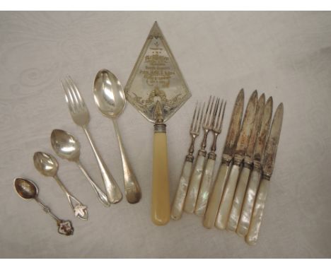 A small selection of flatware including HM silver dessert spoon and fork, souvenir spoons, mother of pearl handled dessert kn