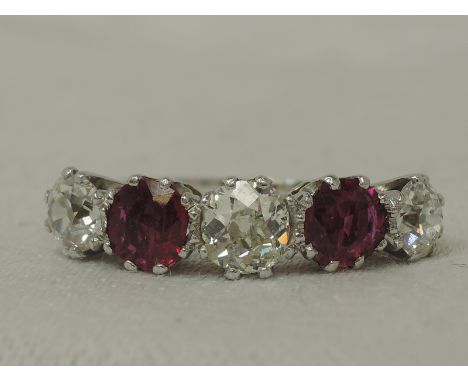 A lady's dress ring having three diamonds, total approx 1.70ct interspersed by two rubies, total approx 1.1ct in a claw set r