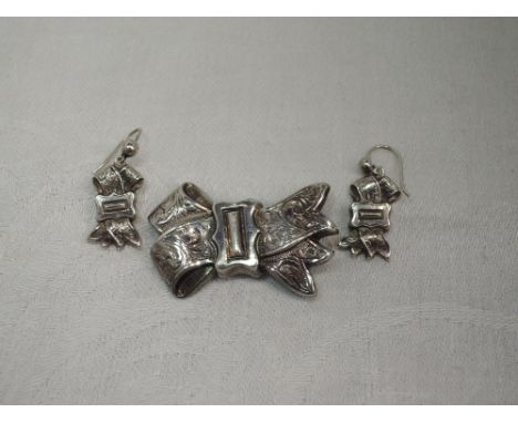 A Victorian style white metal brooch modelled as a bow with matching earrings, no marks, tested as silver