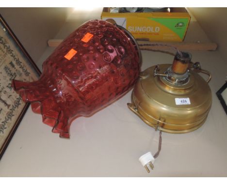 An early 20th century brass oil lamp with large cranberry glass shadeCONDITION REPORTNO VISIBLE FAULTS OR REPAIRS