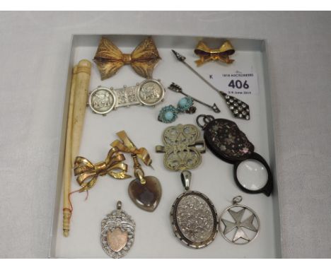 A small selection of white and yellow metal jewellery including 9ct gold bow brooch, Maltese cross pendant, locket, clip earr