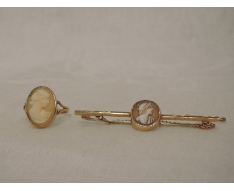 A yellow metal bar brooch stamped 9ct having a central conche shell cameo plaque depicting a centurian and a lady's dress rin