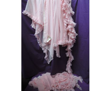 A quantity of vintage Harrods baby pink sheer curtains, trims and similar. Unused with tags.