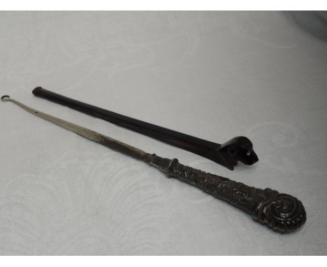 A Victorian silver handled button hook having moulded decoration, Birmingham 1890, makers mark worn, and a long stemmed bakel