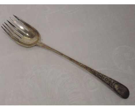 A Georgian silver serving fork having bright cut decoration to stem and terminal, London 1786, John Lambe