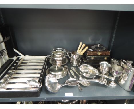 A selection of silver plate including cased and loose flatware, ladle, spirit flask, sauce boat, cream jug, deck of cards cas