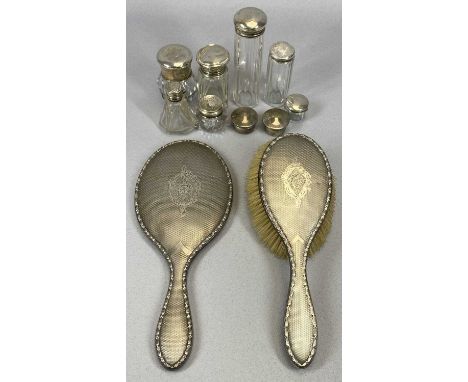 ELEVEN HALLMARKED SILVER DRESSING TABLE ITEMS, nine bearing various Birmingham hallmarks comprising a hand mirror and matchin