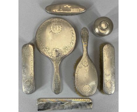 SEVEN SILVER MOUNTED DRESSING TABLE ITEMS comprising a matching five piece circular hand mirror, three brushes and comb set L