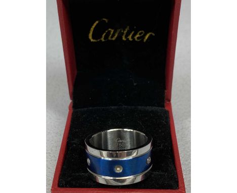 WHITE &amp; BLUE METAL RING, the centre set with a band of screws (one missing), marked 'Cartier 750 2209', size W, in red bo