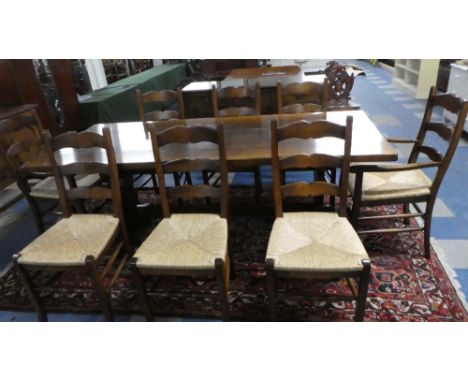 A Refectory Oak Dining Table (214x90cms) Together with Eight Rush Seated Ladder Back Dining Chairs Includung Two Carvers.