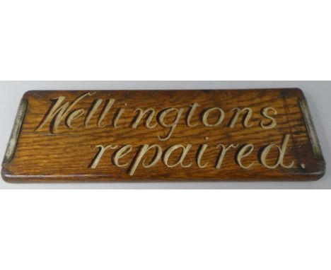 A Vintage Painted Oak Shop Advertising Sign 'Wellingtons Repaired' 42cms