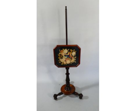 A Victorian Mahogany Pole Tapestry Fire Screen on Three Turned Feet.