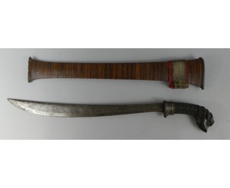 A Late 19th Century Indonesian Sword and Scabbard. Carved Horn Handle with Grotesque Face, Pommel having Orange and Black Bea