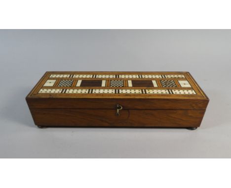 An Early 19th Century Rosewood Games Box.. The Top with an Inlaid Cribbage Board. 28x9x6cms