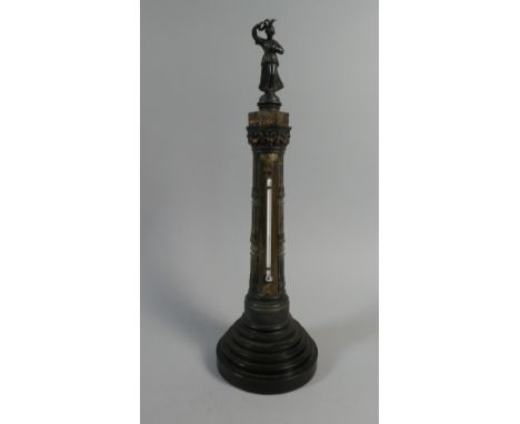 A 19th Century Desk Thermometer Modelled as a Spelter Figure on a Gothic Pillar. 32cms High