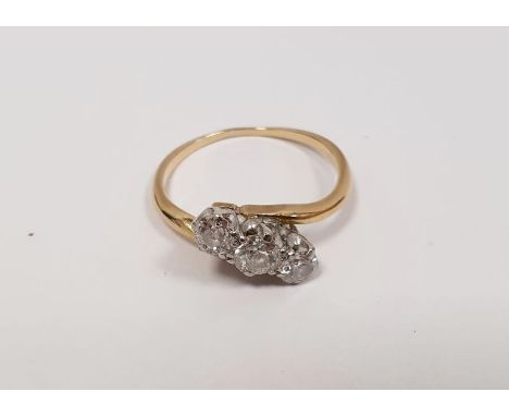 Gold and diamond three-stone crossover ring 