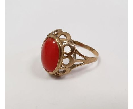 Gold-coloured metal and coral ring set oval cabochon stone, the ring marked '333'