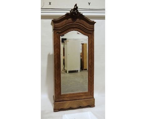 Continental walnut armoire with carved pediment, mirrored door, on bracket feet, 104cm x 240cm