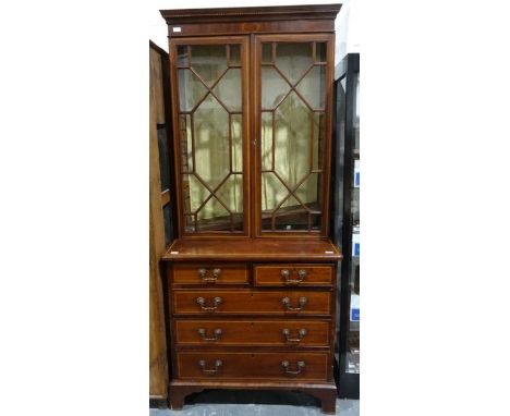 Edwardian mahogany and satinwood banded bookcase cabinet, the moulded cornice above two astragal-glazed doors enclosing shelv