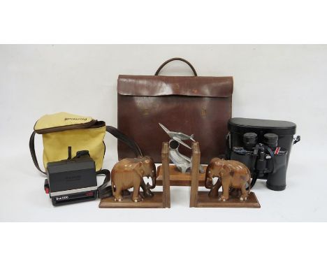 Aluminium model of a spitfire, a pair of carved hardwood elephant bookends, a pair of Swift Grand Prix binoculars, a Polaroid