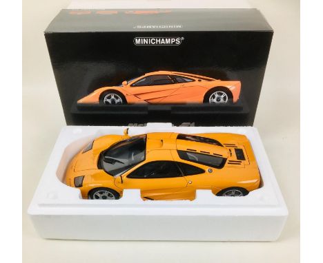 A Minichamps die-cast 1:12 scale model 1994 Mclaren F1 road car in orange, with original box. 