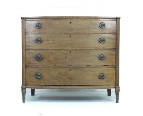 A 19th century mahogany bow fronted chest of four drawers, with fluted columns, boxwood stringing to the drawers and raised o